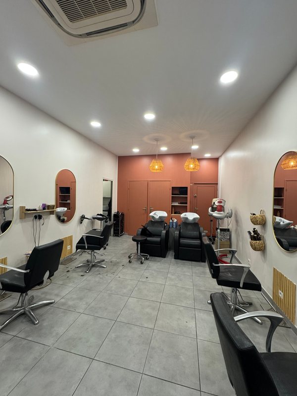 A peach-walled corner of the studio with two backwash basins