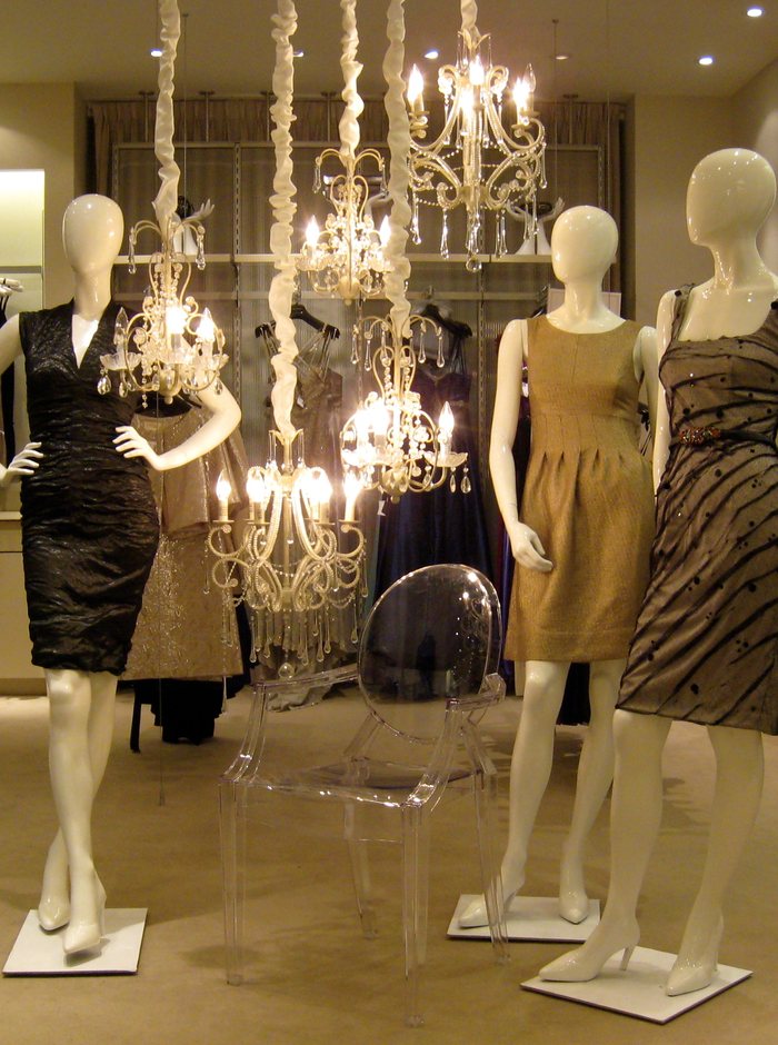 A row of dressed mannequins in a department store