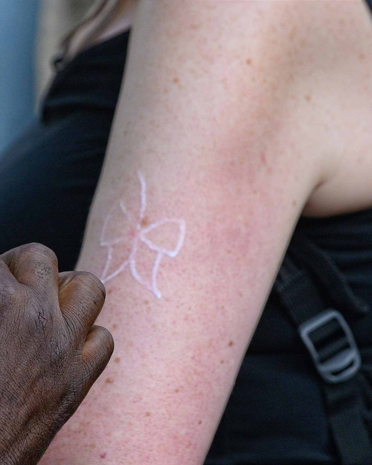 A stencil outline transferred onto an upper arm before the first line is drawn.