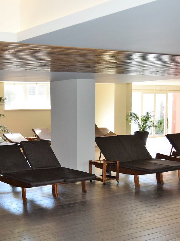 Row of wooden loungers by the windows in a quiet relaxation room