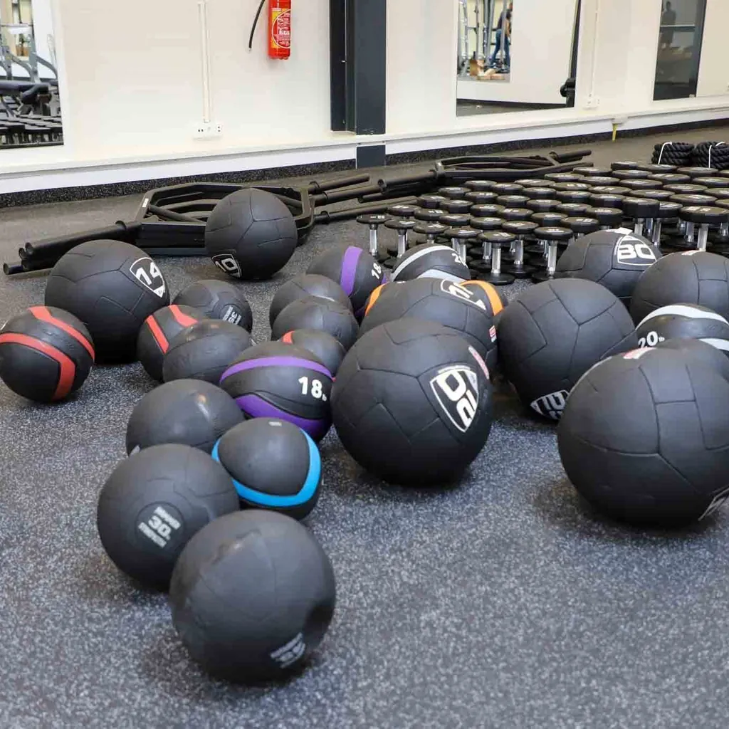Empty practical lab with medicine balls and racked weights