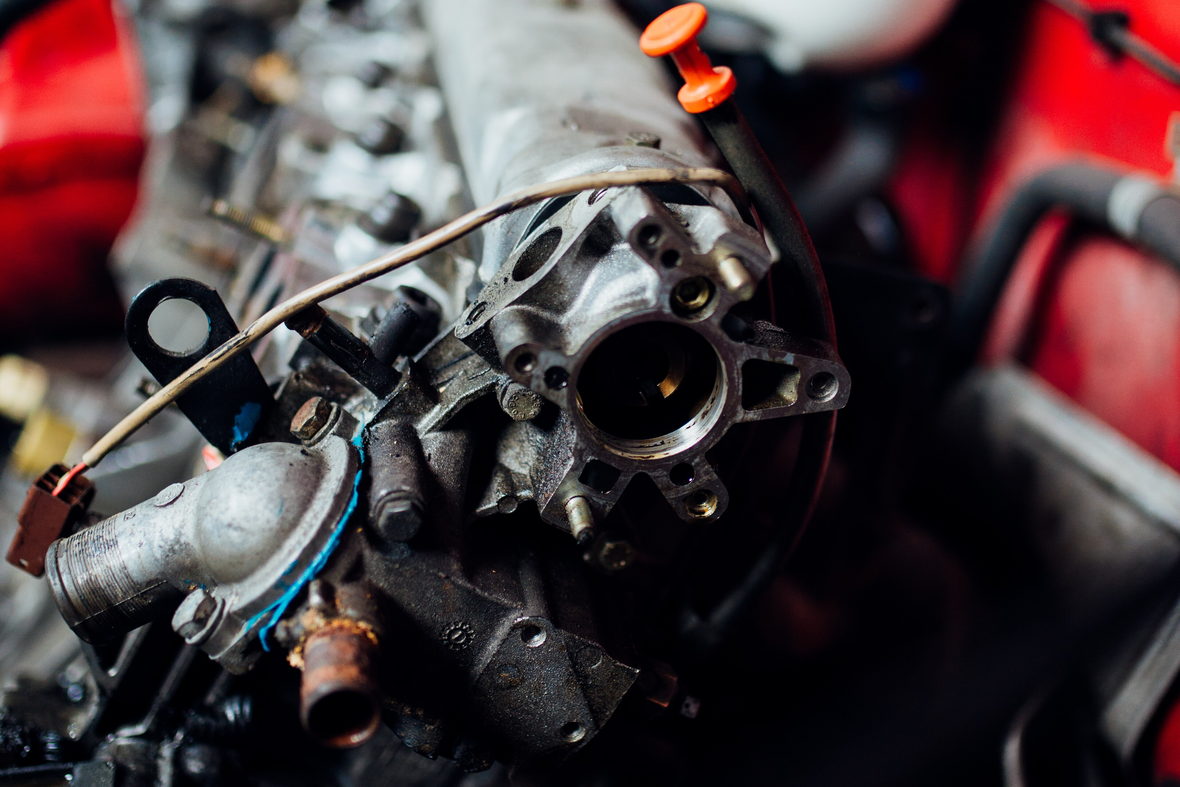 An open engine bay with components exposed during a mechanical check.