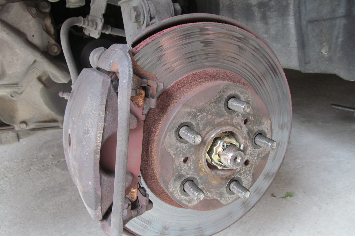 A brake caliper and disc mounted on a wheel hub.