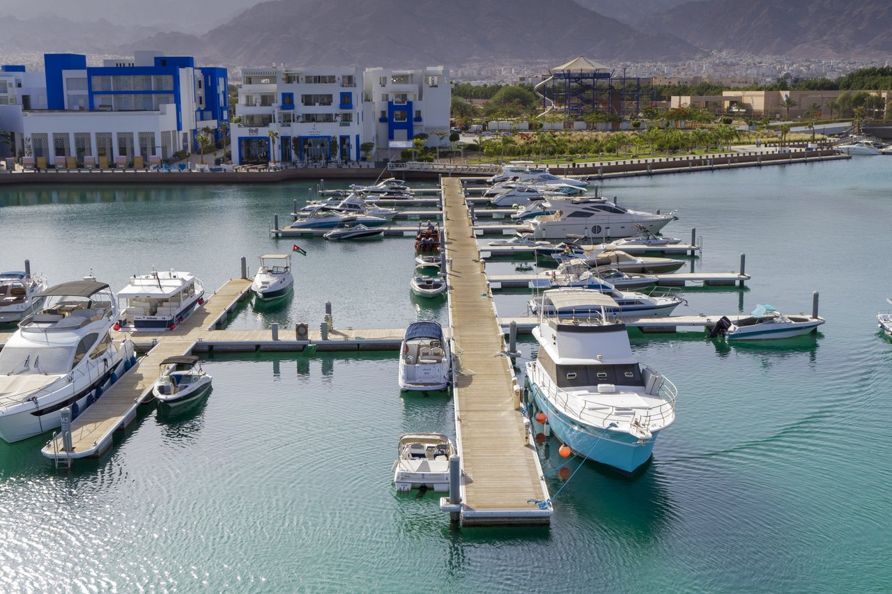 Homes and moored boats along the marina channel at Marisol Bay