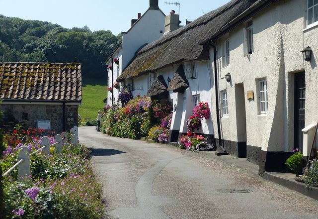 The Orchard Hill Cottage — thatched storybook cottage on a flower-lined lane