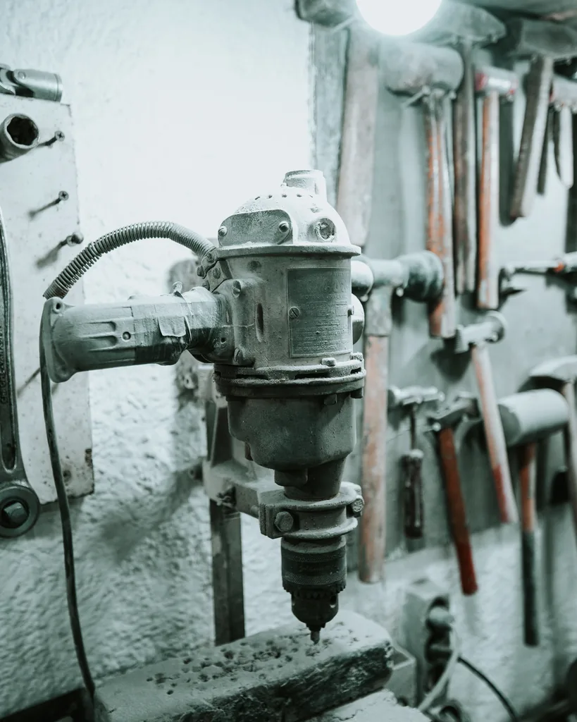 A tall view of the workshop tool wall and bench machinery.