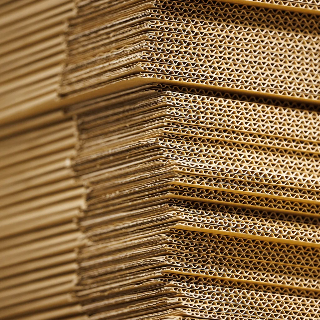 Plain cardboard boxes stacked and waiting to be labelled.