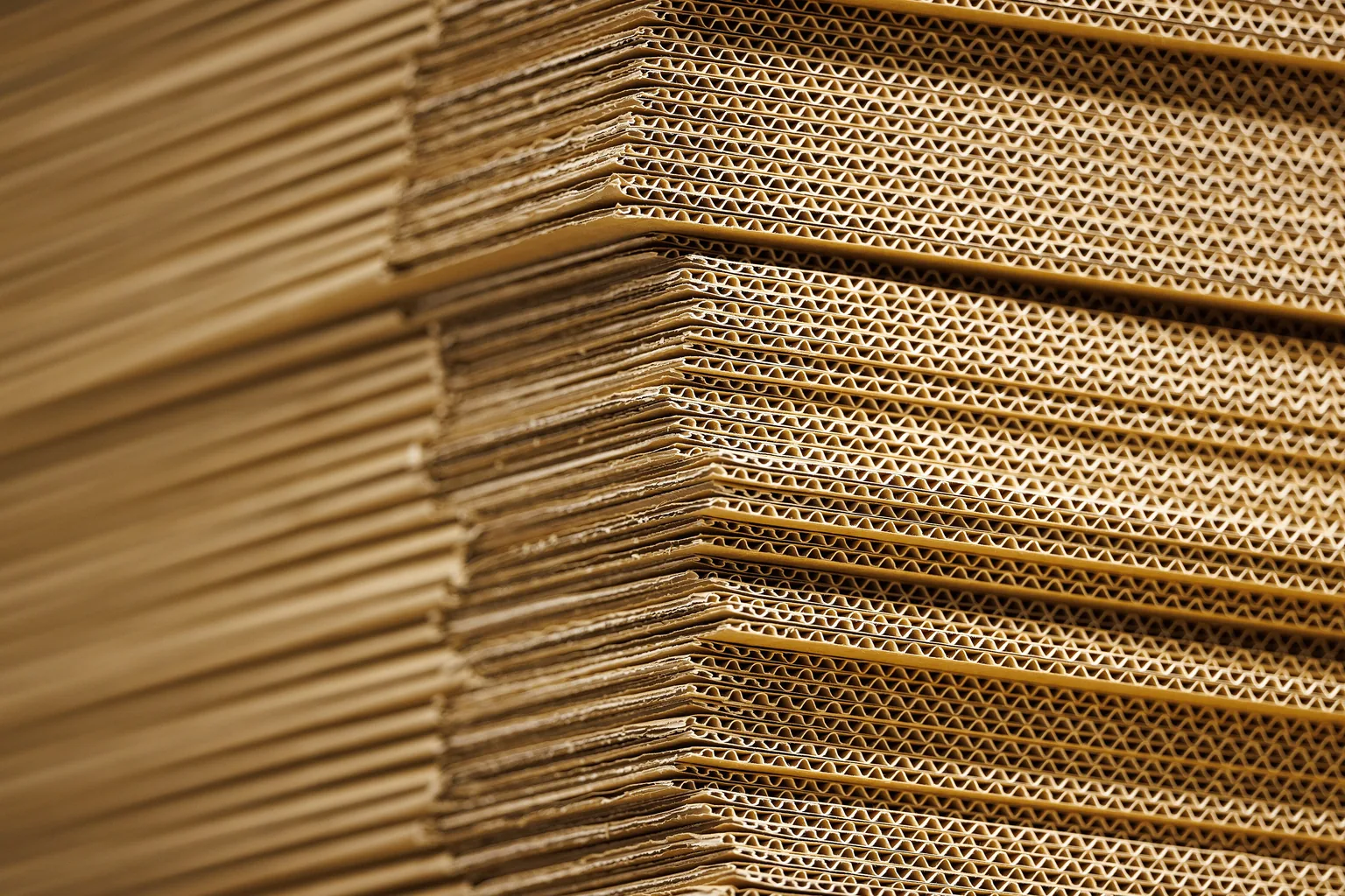 Plain cardboard moving boxes stacked in a packing area