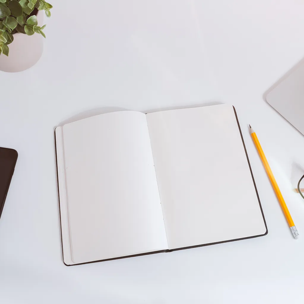 Open notebook and pencil on a bright planning desk