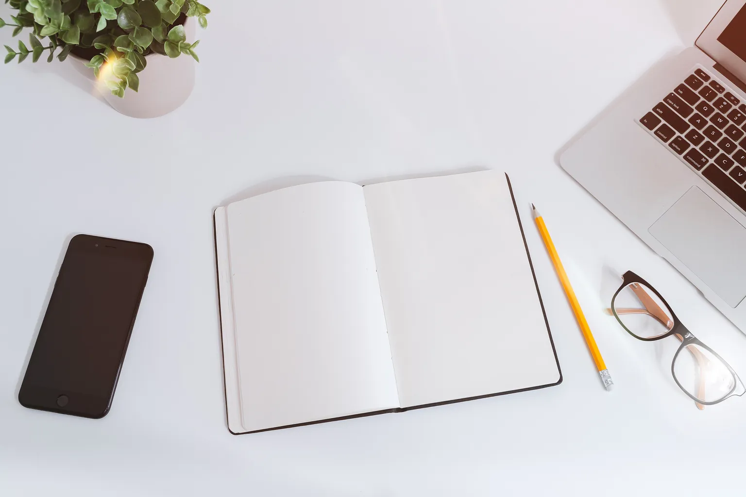 Open notebook, pencil and notes arranged on a planning desk