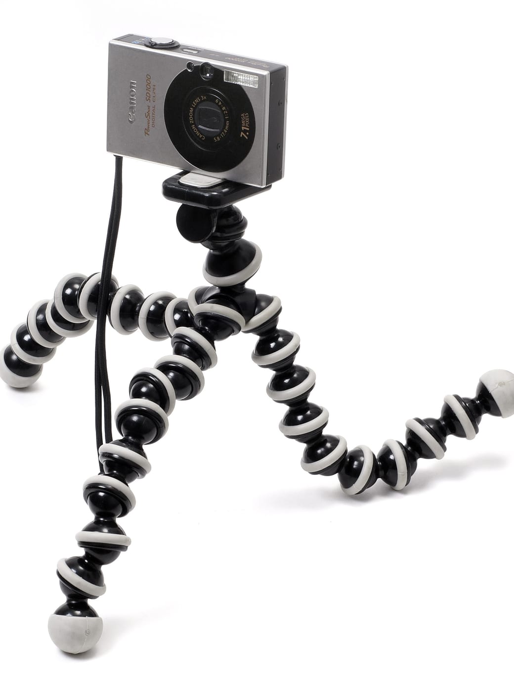A small digital camera mounted on a flexible-legged tripod.