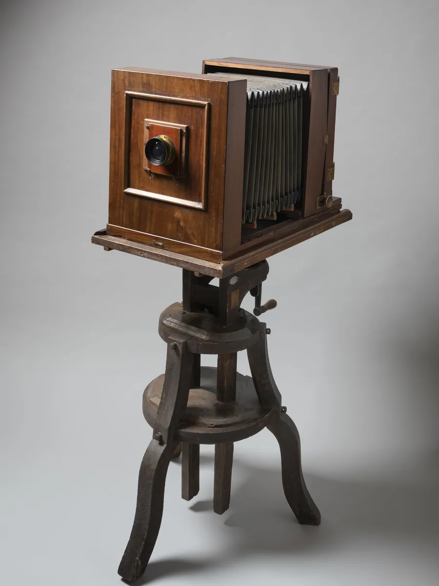 Large-format camera standing on its wooden tripod