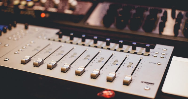 Close view along a bank of console faders
