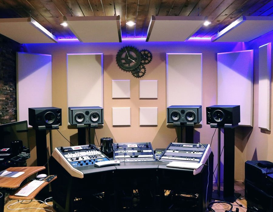 Control room with monitor speakers either side of the desk and acoustic panels