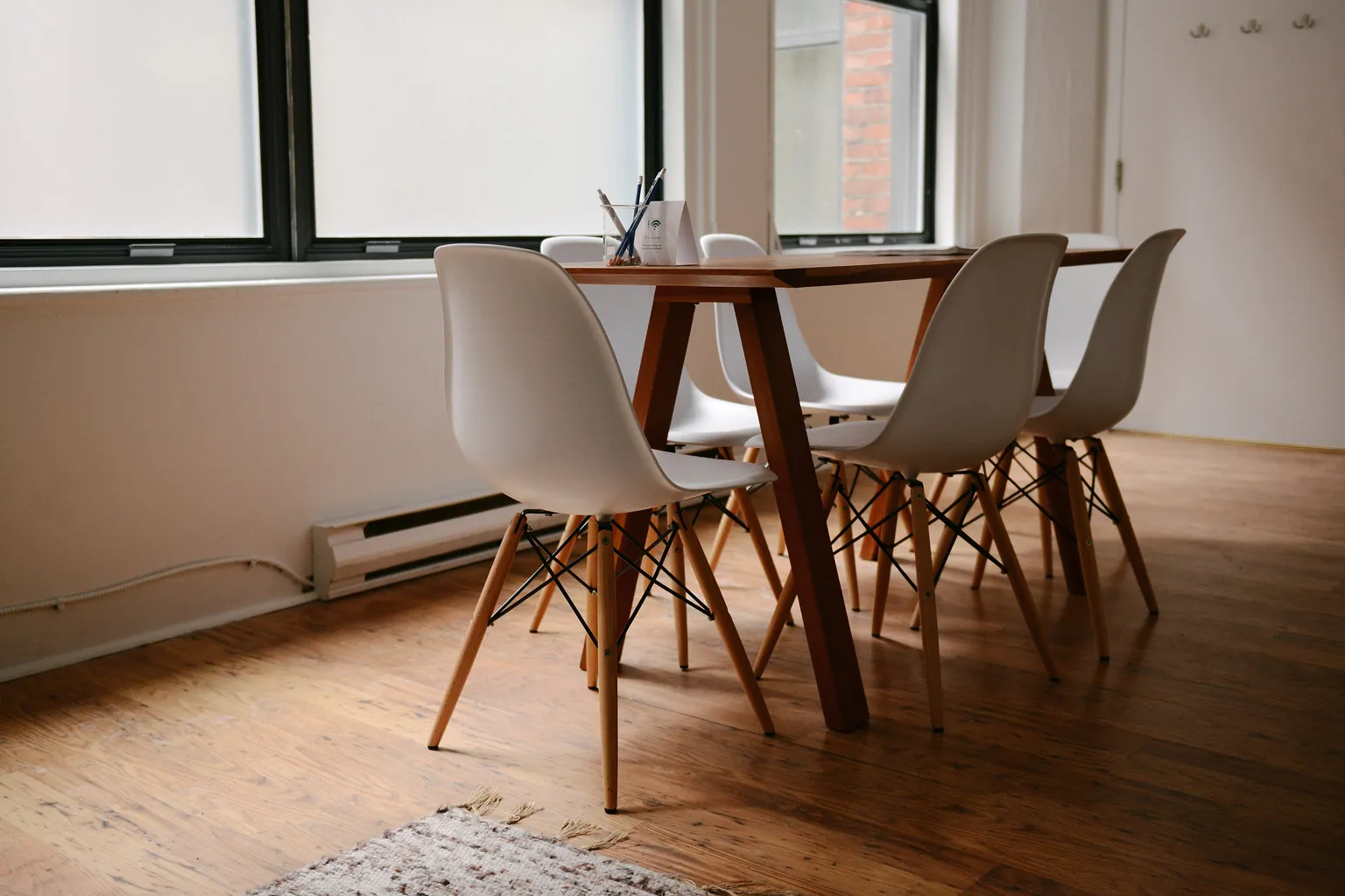 Meeting table and matched chairs beside a daylight window